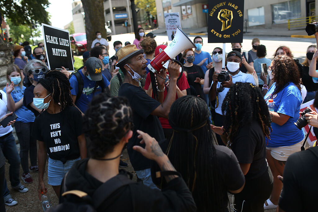 Rev. Darrel Gray uses a megaphone to address Jefferson City police officers